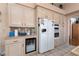 Bright kitchen featuring white appliances, cabinets, and tile floors at 7815 Windward Rd, Las Vegas, NV 89147