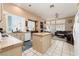 Open concept living area combines the kitchen and Gathering room, perfect for entertaining at 7815 Windward Rd, Las Vegas, NV 89147