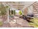Inviting outdoor patio area with pergola, stone flooring, seating, and grill for relaxing and entertaining at 7815 Windward Rd, Las Vegas, NV 89147