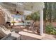 Covered patio with outdoor seating overlooking pool and desert landscaping at 7815 Windward Rd, Las Vegas, NV 89147
