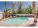 Gorgeous pool with rock waterfall, surrounded by lush landscaping, offering a private retreat at 7815 Windward Rd, Las Vegas, NV 89147