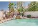 Picturesque pool waterfall surrounded by lush landscaping and desert plants for a relaxing outdoor oasis at 7815 Windward Rd, Las Vegas, NV 89147