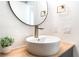 Close up on modern bathroom with stylish vessel sink, wood counter, and textured walls at 7932 Diamond Rock Way # 101, Las Vegas, NV 89128