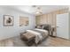 Inviting bedroom with paneled wall, wood-look flooring, a comfortable bed, and stylish decor at 7932 Diamond Rock Way # 101, Las Vegas, NV 89128