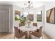 Bright dining area with a round marble table, modern lighting, and large windows at 7932 Diamond Rock Way # 101, Las Vegas, NV 89128