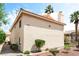 Exterior view of a two-story building with stucco siding and a well-maintained landscape at 7932 Diamond Rock Way # 101, Las Vegas, NV 89128