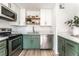 Stylish updated kitchen with stainless steel appliances and green cabinets at 7932 Diamond Rock Way # 101, Las Vegas, NV 89128