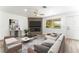 Comfortable living room with stylish furnishings, fireplace, ceiling fan, and a view to the outdoors at 7932 Diamond Rock Way # 101, Las Vegas, NV 89128