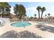 Community pool area surrounded by lush landscaping, lounge chairs, and inviting atmosphere at 7932 Diamond Rock Way # 101, Las Vegas, NV 89128