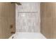 Stylish shower-tub combination with neutral tile, a convenient niche, and bronze fixtures at 7932 Diamond Rock Way # 101, Las Vegas, NV 89128