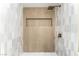 Modern walk-in shower with light tile, a niche, and sleek bronze fixtures at 7932 Diamond Rock Way # 101, Las Vegas, NV 89128