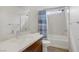 Bright bathroom with white vanity, modern fixtures, and a shower-tub combination with curtain at 8016 Carpenter Creek Ave, Las Vegas, NV 89113