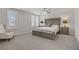Bright bedroom with large bed, neutral walls, carpet and white plantation shutters for privacy at 8016 Carpenter Creek Ave, Las Vegas, NV 89113