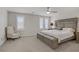 Relaxing bedroom featuring a ceiling fan, carpeted floors, and windows with plantation shutters at 8016 Carpenter Creek Ave, Las Vegas, NV 89113