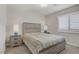 Cozy bedroom featuring a bed, neutral walls, carpet and white plantation shutters for privacy at 8016 Carpenter Creek Ave, Las Vegas, NV 89113