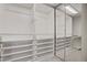 Walk-in closet featuring an abundance of storage with shelving, drawers, and mirrored door at 8016 Carpenter Creek Ave, Las Vegas, NV 89113