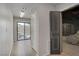 Hallway that leads to backyard and home theater, featuring hardwood floors and neutral wall colors at 8016 Carpenter Creek Ave, Las Vegas, NV 89113
