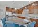 Modern kitchen with stainless steel appliances, granite countertops, and stylish blue counter seating at 8016 Carpenter Creek Ave, Las Vegas, NV 89113