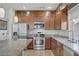 Open kitchen featuring stainless steel appliances, granite countertops, and rich wood cabinetry at 8016 Carpenter Creek Ave, Las Vegas, NV 89113