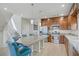 Bright kitchen features an island with a stone countertop, stainless steel appliances and wooden cabinets at 8016 Carpenter Creek Ave, Las Vegas, NV 89113