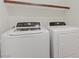 Convenient laundry room featuring a washer and dryer, with overhead storage space at 8016 Carpenter Creek Ave, Las Vegas, NV 89113