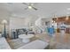 Spacious living room with hardwood floors, neutral walls, a ceiling fan, and seamless flow into the kitchen at 8016 Carpenter Creek Ave, Las Vegas, NV 89113