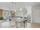 Open-concept living space with a kitchen island, staircase, and a comfortable seating area at 8016 Carpenter Creek Ave, Las Vegas, NV 89113