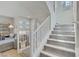 Carpeted staircase leading to the upper level with a view of the living area at 8016 Carpenter Creek Ave, Las Vegas, NV 89113