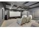 Relax in this modern theater room with comfortable seating and an impressive entertainment setup at 8016 Carpenter Creek Ave, Las Vegas, NV 89113