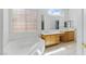 Light-filled bathroom features a double vanity, soaking tub, and privacy glass window at 8114 Lapis Harbor Ave, Las Vegas, NV 89117