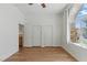 Bright bedroom with new flooring, an arched window, and closet space at 8114 Lapis Harbor Ave, Las Vegas, NV 89117