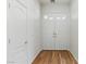 Bright entryway featuring a white double door, hardwood flooring, and white trim, offering a clean, welcoming ambiance at 8114 Lapis Harbor Ave, Las Vegas, NV 89117