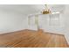 Spacious living room with hardwood floors, ample natural light, and a stylish chandelier, perfect for relaxation at 8114 Lapis Harbor Ave, Las Vegas, NV 89117