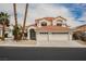 Charming two-story home with a three-car garage and mature palm trees enhancing the curb appeal at 8140 Bay Harbor Dr, Las Vegas, NV 89128