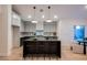 Elegant kitchen with a large center island, modern appliances, and stylish pendant lighting at 8140 Bay Harbor Dr, Las Vegas, NV 89128