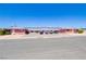 Street view of low-rise apartment complex with red brick, pedestrian walkways and front parking at 820 A Ave, Boulder City, NV 89005