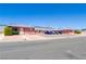 Street view of low-rise apartment complex with red brick, pedestrian walkways and front parking at 820 A Ave, Boulder City, NV 89005