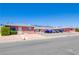 Street view of low-rise apartment complex featuring red brick, maintained yard, and on-site parking at 820 A Ave, Boulder City, NV 89005