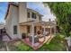 Virtually Staged: Backyard view of the two-story home featuring a covered patio and outdoor seating area at 8236 Bermuda Beach Dr, Las Vegas, NV 89128
