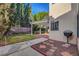 Backyard with a pergola-covered patio, mature trees, grass, and patio for outdoor enjoyment at 8236 Bermuda Beach Dr, Las Vegas, NV 89128