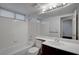 Bright bathroom features a shower-tub combo and a dark wood vanity with white countertop at 8236 Bermuda Beach Dr, Las Vegas, NV 89128