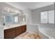 Bathroom featuring double sinks, a large mirror, and a soaking tub at 8236 Bermuda Beach Dr, Las Vegas, NV 89128