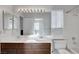 Bright bathroom with a dual sink vanity, large mirror, tub-shower combo and neutral tiling at 8236 Bermuda Beach Dr, Las Vegas, NV 89128