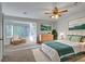 Staged bedroom with carpeting, bay window, and modern furnishings create a comfortable and inviting space at 8236 Bermuda Beach Dr, Las Vegas, NV 89128
