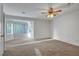 Spacious carpeted bedroom with a ceiling fan and a bright bay window at 8236 Bermuda Beach Dr, Las Vegas, NV 89128