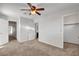 Bedroom with multiple doorways, ceiling fan, and neutral carpet at 8236 Bermuda Beach Dr, Las Vegas, NV 89128