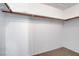 Walk-in closet with wooden clothing rods and neutral carpeting at 8236 Bermuda Beach Dr, Las Vegas, NV 89128