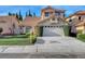 Charming two-story home featuring a well-manicured lawn, a red tile roof and a two-car garage at 8236 Bermuda Beach Dr, Las Vegas, NV 89128