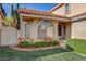 Lovely home with an arched window and a lush lawn accented with blooming flowers at 8236 Bermuda Beach Dr, Las Vegas, NV 89128