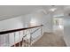 Hallway featuring carpeted floors and a wood railing overlooking the stairway at 8236 Bermuda Beach Dr, Las Vegas, NV 89128